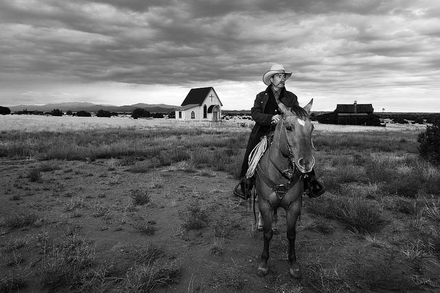 A Cowboy riding a horse