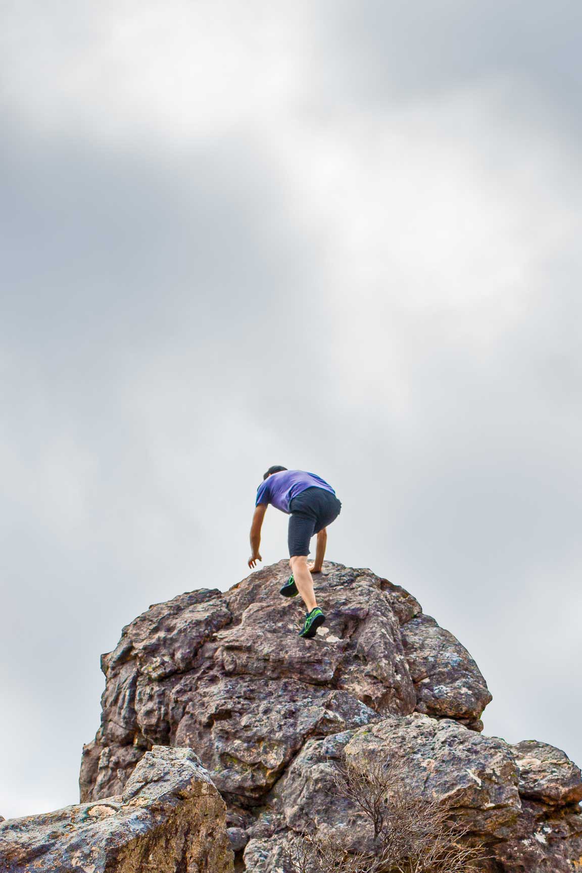 Man climbing a boulder